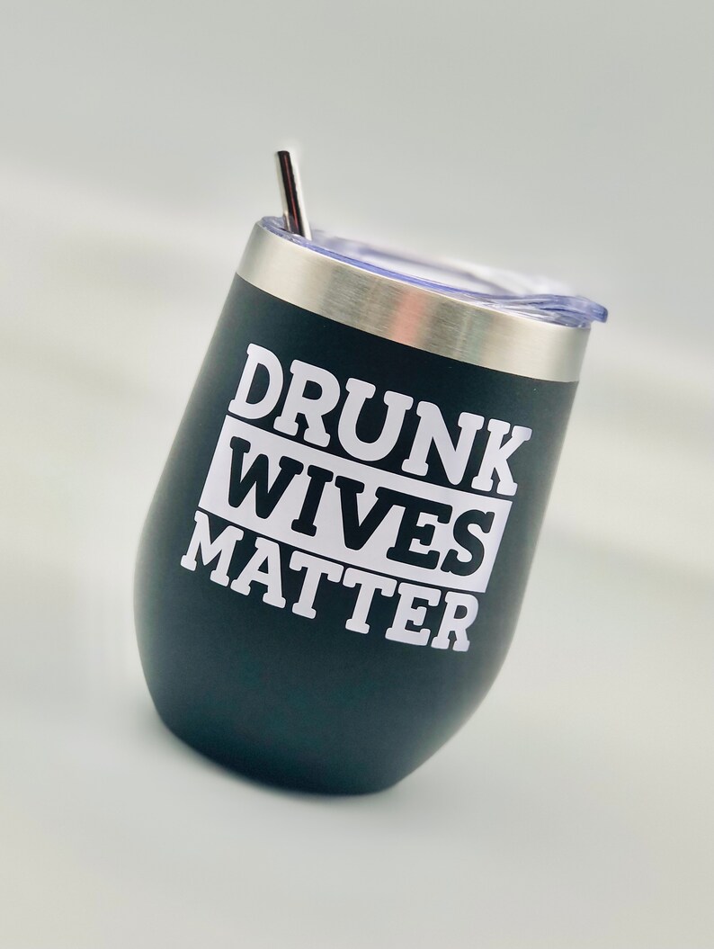 May include: Black stainless steel wine tumbler with a white inscription that reads "Drunk Wives Matter".