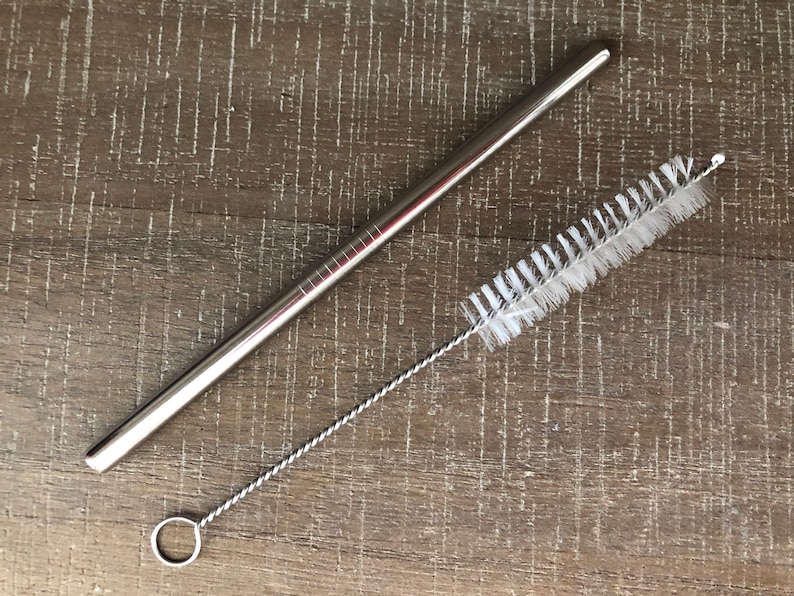 May include: A silver metal drinking straw with a white cleaning brush. The straw is about 10 inches long and the brush is about 8 inches long.