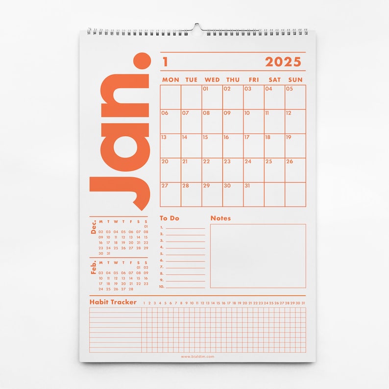 May include: A white 2025 wall calendar with an orange "Jan" graphic. The calendar grid is orange, with sections for "To Do," "Notes," and a habit tracker. The calendar is spiral-bound at the top.