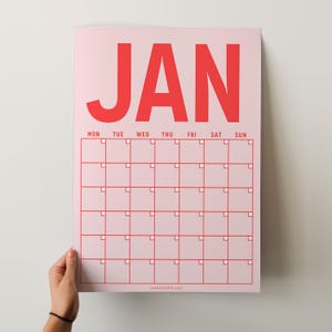 May include: A pink printable calendar for January with the month name in bold red letters. The calendar has a grid with days of the week labeled and blank squares for each day. The website address www.briddled.com is printed at the bottom.