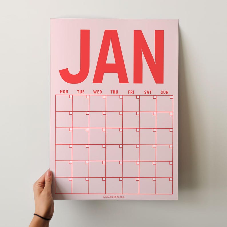 May include: A pink printable calendar for January with the month name in bold red letters. The calendar has a grid with days of the week labeled and blank squares for each day. The website address www.briddled.com is printed at the bottom.