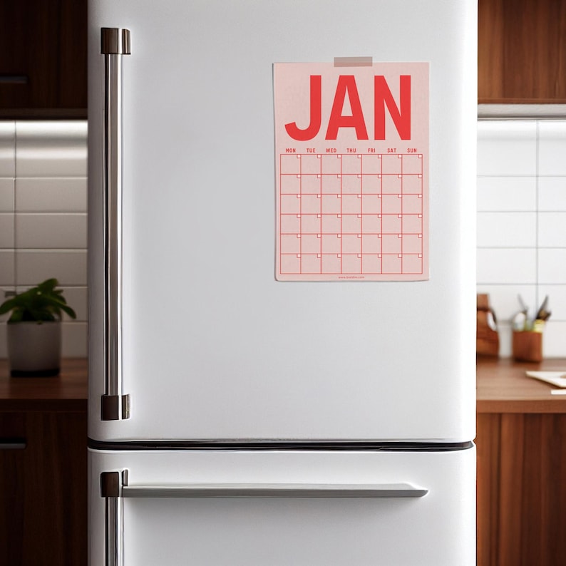 May include: A pink calendar with the word "JAN" in red letters at the top. The calendar has a grid of squares for each day of the month, with the days of the week labeled at the top.