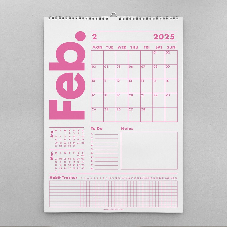 May include: A white wall calendar for February 2025, with a pink grid and text. The word "Feb." is vertically printed in large pink letters. Includes a "To Do" section, a "Notes" section, and a habit tracker.