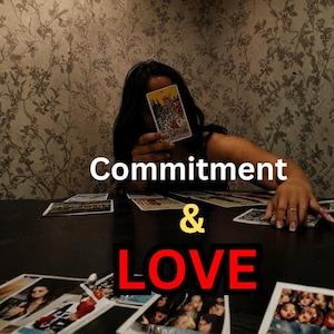 May include: A person holding a tarot card in front of their face, with the words "Commitment & Love" overlaid on the image. Several tarot cards are scattered on a dark table.