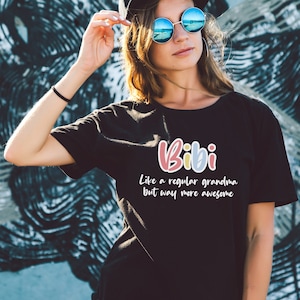 May include: Black t-shirt with the text "Bibi Like a regular grandma but way more awesome" in colorful letters.
