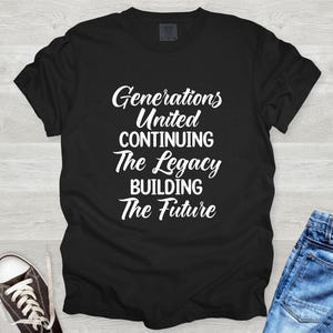 May include: Black t-shirt with white text: "Generations United Continuing The Legacy Building The Future." The shirt is paired with blue jeans and black and white sneakers. A casual, everyday wear item.