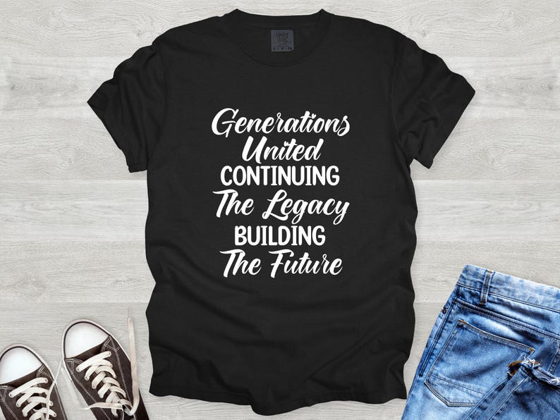 May include: Black t-shirt with white text: "Generations United Continuing The Legacy Building The Future." The shirt is paired with blue jeans and black and white sneakers. A casual, everyday wear item.