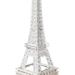 May include: A clear crystal Eiffel Tower model. The famous landmark is depicted with a detailed, geometric design. The tower's lattice structure and spire are visible, demonstrating the intricate craftsmanship. A decorative item, ideal for display.