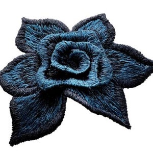 May include: A blue embroidered flower with a layered design. The flower has a dark blue outline and a lighter blue centre.