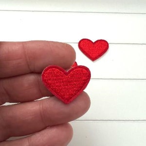 May include: Two red felt heart patches. The hearts are about 1 inch in size and are perfect for adding a touch of love to any project.