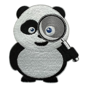 May include: An embroidered patch featuring a cartoon panda with black and white fur. The panda has blue eyes and is holding a magnifying glass over its left eye. The design is outlined in a light gray border, creating a distinct shape.