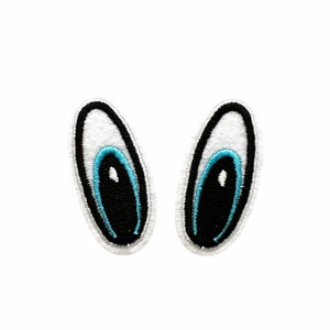 May include: Two white felt bunny ears with black and blue embroidered eyes.
