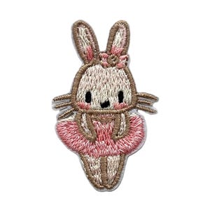May include: Embroidered iron-on patch of a brown bunny wearing a pink tutu. The bunny has a pink bow on its head and a sweet expression.