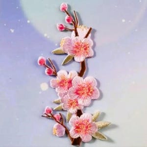May include: Pink embroidered cherry blossom flower patch with brown stems and green leaves.