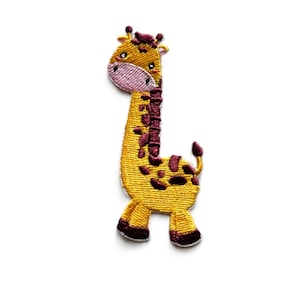 May include: An embroidered giraffe patch in yellow and brown with a pink nose and brown hooves.