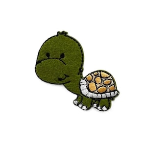 May include: Green felt embroidered patch of a cartoon turtle with a yellow and white shell.