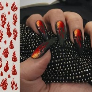 May include: Red flame nail decals on a white sheet. The sheet has the text "XF-3286" printed on it. The decals are in various sizes and shapes.