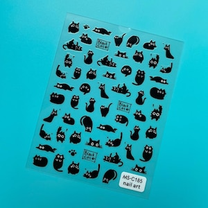 May include: Transparent sheet of nail art stickers featuring black cat designs. The sheet includes cats in various poses, some with the text "Black Cat". The bottom right corner has the text "MS-C185 nail art".
