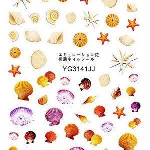 May include: A sheet of colorful seashell and starfish nail stickers. The stickers are in various shades of orange, yellow, purple, and red. The text on the sheet reads "エミュレーション花  装飾ネイルシール  YG3141JJ".