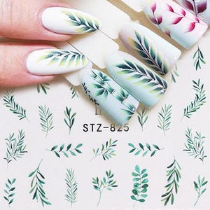 May include: Nail art stickers featuring botanical designs. The stickers include green leaf and bamboo patterns on a white and light blue background. The text "STZ-825" is visible on the stickers.
