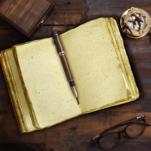 May include: A vintage-style leather-bound journal with blank pages, a fountain pen, and a compass on a wooden surface.