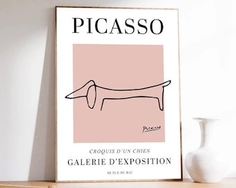 May include: A black and white line drawing of a dog on a pink background. The text "PICASSO" is at the top of the image. The text "CROQUIS D'UN CHIEN GALERIE D'EXPOSITION 58 RUE DU BAC" is at the bottom of the image.