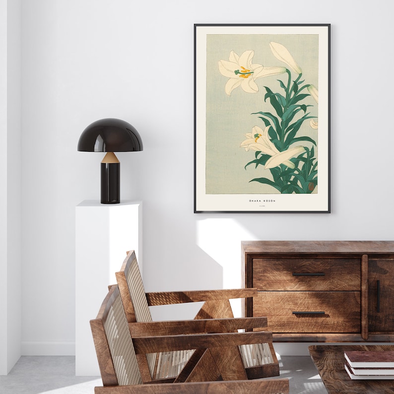 May include: A vintage Japanese woodblock print of white lilies with green leaves on a light blue background. The print is framed in black and has the text "OHARA SOSON" and "1928" in the bottom right corner.