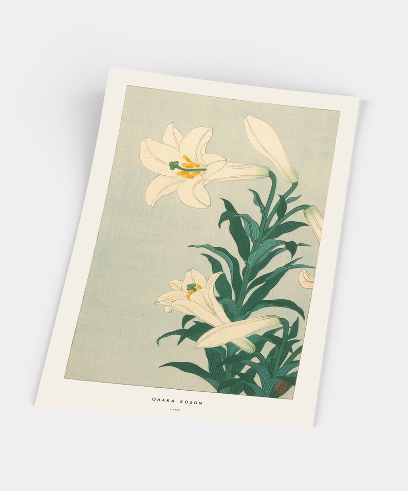 May include: A vintage Japanese woodblock print of white lilies with green leaves on a light blue background. The print is signed "Ohara Koson" in the bottom right corner.