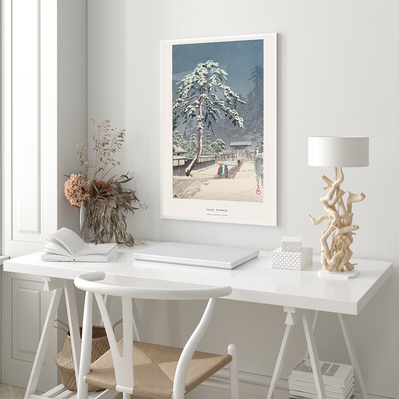 May include: A snowy landscape with a pine tree covered in snow and a small group of people walking on a path. The image is a Japanese woodblock print titled "Yuki-Fumi" by Kawase Hasui.
