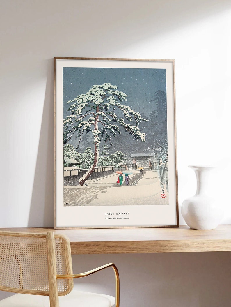May include: A vintage Japanese woodblock print depicting a snowy scene with a large pine tree in the foreground. The print is titled "Hasui Kawase" and features a traditional Japanese temple in the background.