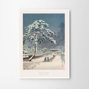 May include: A woodblock print of a snowy Japanese landscape with a large pine tree covered in snow. Two figures walk under umbrellas in the foreground. The print is titled "Hasui Kawase" and "Todai Hongwanji Temple".