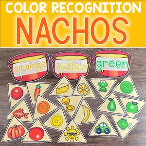 May include: A color recognition game for kids featuring a set of triangular chips with various images on them. The chips are meant to be sorted into three bowls labeled "orange", "yellow", and "green".