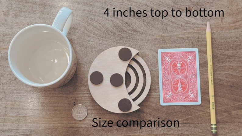 May include: A wooden coaster with three brown circular magnets, a playing card, a pencil, a mug, and a coin are displayed on a wooden surface. The text "4 inches top to bottom" and "Size comparison" are visible.