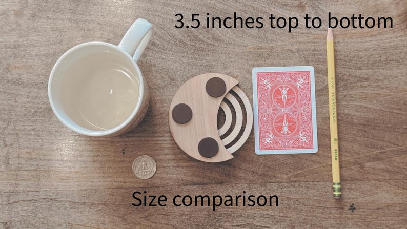 May include: A wooden coaster with three brown circular accents, a playing card, a pencil, a coffee mug, and a coin are arranged on a wooden surface. The text "3.5 inches top to bottom" and "Size comparison" are visible.