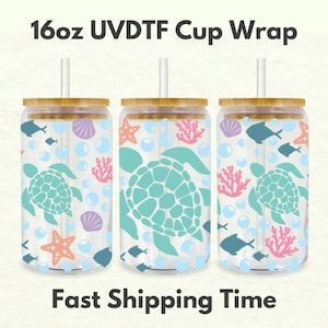 May include: Three 16oz clear glass cups with bamboo lids and straws. Each cup features a sea turtle design with coral, starfish, seashells, and bubbles. The text "16oz UV DTF Cup Wrap" is at the top of the image. The text "Fast Shipping Time" is at the bottom of the image.