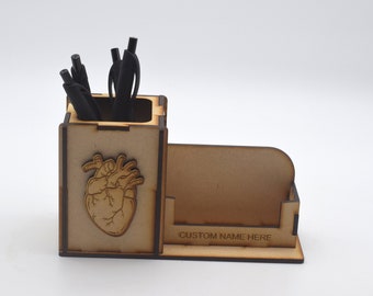 May include: Wooden desk organizer with a heart design and a separate compartment for business cards. The compartment has the text "CUSTOM NAME HERE" engraved on it.