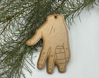 May include: Wooden Christmas ornament shaped like a hand with a bandage on one finger.