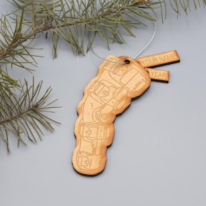 May include: Wooden Christmas ornament shaped like a ski boot with a personalized tag that says "YOUR NAME" and "YEAR".