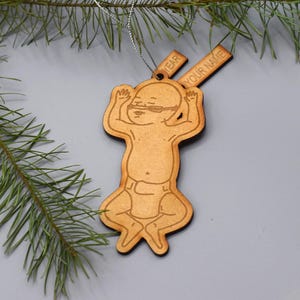 May include: Wooden Christmas ornament shaped like a baby with the text "YEAR" and "YOUR NAME" on the top.