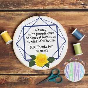May include: A blue and white cross-stitch embroidery hoop with a yellow rose and the text "We only invite people over because it forces us to clean the house P.S. Thanks for coming".