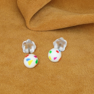 Small ball stud earrings with rainbow flecks. Tiny 4mm sphere studs, handmade with matte finish. Pride, LBGT jewellery for sensitive skin.