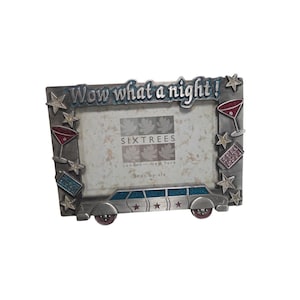 May include: A rectangular metal picture frame featuring the text Wow what a night! at the top. The frame is decorated with silver stars, two martini glasses, a ticket, and a limousine at the base. The center insert displays Sixtrees branding.
