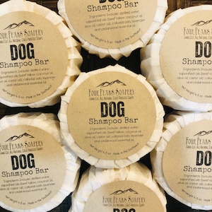 May include: Six brown paper wrapped bars of dog shampoo with the text "Four Peaks Soapery Hand Cut, All Natural, Cold Process Soaps DOG Shampoo Bar" and the ingredients listed. Each bar weighs 4-5 ounces and is made in the Southwest.