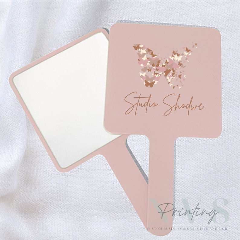 Personalised Handheld Mirror for Make Up Artist in blush pink colour with printed business logo on it, Studio Shodwe with printed buterfly logo, custom print mirror for salon hairdresser lash tech or brow tech and any beautician, bridal gift