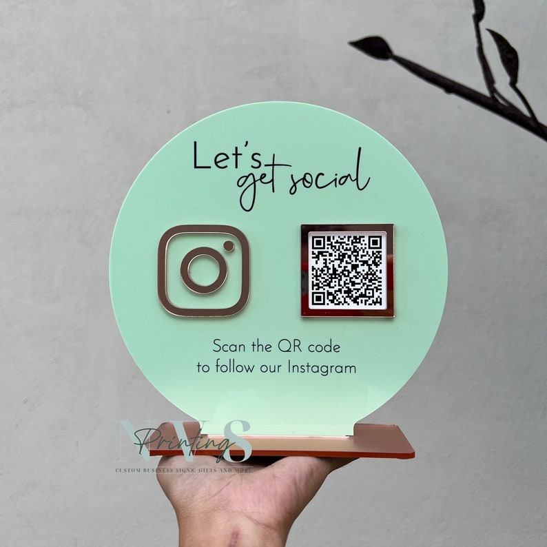 QR Code social media display stand in green mint acrylic backing, lets get social on top and instagram logo on the left in rose gold mirror acrylic and instagram QR code, instagram handle under the QR code and scan the QR code to follow our instagram