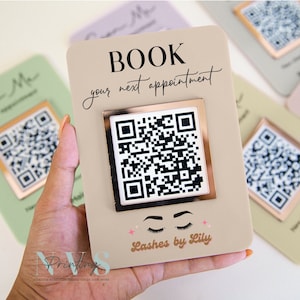 May include: A beige card with the text "BOOK your next appointment" and a gold-framed QR code. The card also features a pair of eyelashes and the text "Lashes by Lily".