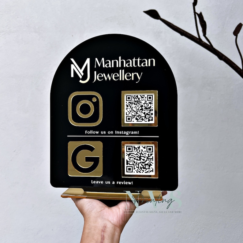 arch QR Code social media display stand in black acrylic, business logo on top, instagram google logo on the left in gold mirror acrylic, instagram google QR codes on the left, follow us on instagram and leave us a review written under each QR