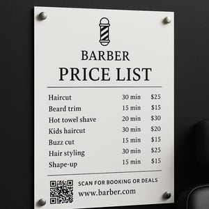 May include: A white barber price list sign with black text and a barber pole graphic. Services include haircuts, beard trims, and hot towel shaves. The sign is mounted on a dark wall with silver hardware.