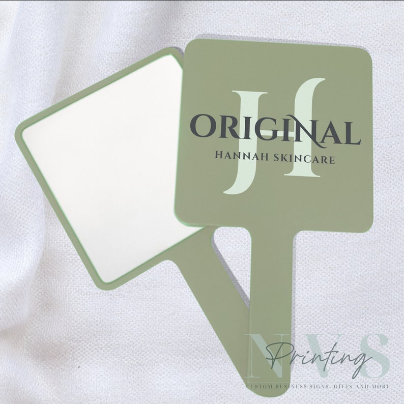 Personalised Handheld Mirror for Make Up Artist in sage green colour with printed business logo on it in white and taupe, Original Hannah skincare logo, custom print mirror for salon hairdresser lash tech or brow tech and any beautician, bridal gift