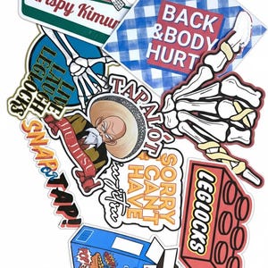 May include: A collection of colorful stickers with various designs and text. Includes a donut with a black belt, a skeleton hand, a blue and white checkered square with "BACK & BODY HURT", and a cereal box.
